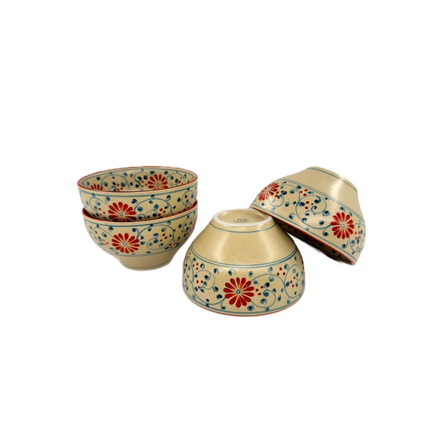 A charming set of four Bat Trang ceramic bowls featuring a colorful hand-painted floral and scrolling vine motif. Each...