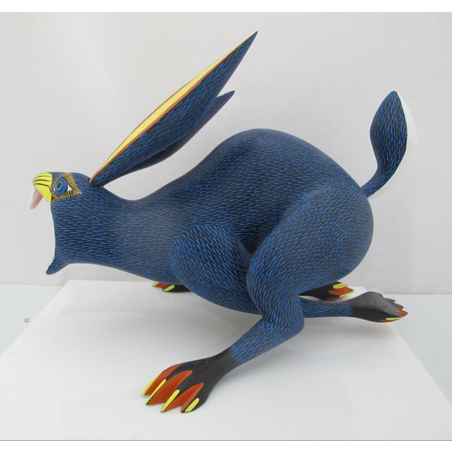 Hand-carved and hand-painted Oaxacan Alebrije sculptural figurine depicting a running rabbit. Hand crafted from copal wood...