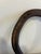 An authentic antique cast iron horseshoe displaying a naturally weathered surface and rich rust patina acquired through...
