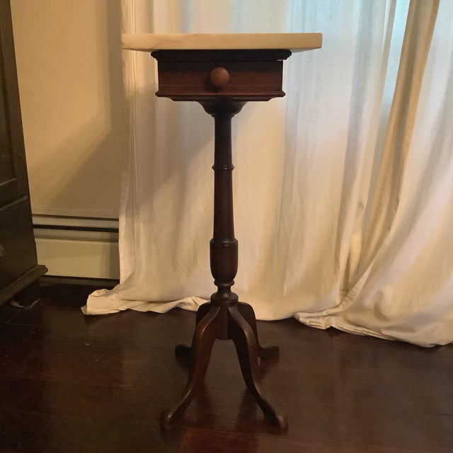 Victorian marble top stand. Measures 30" height; 12" x 18" marble top. Features one drawer and marble top.