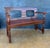 Spanish Renaissance Revival bench crafted in solid oak, 20th century. The bench features a paneled backrest with...