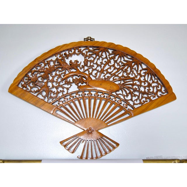 A Japanese hand-sculpted, nature display of cherry blossom, birds and bamboo tree, rosewood wall fan. Sadly it needs...