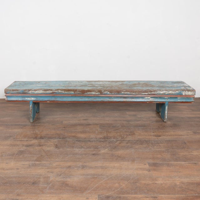 Late 19th-century Swedish oak bench with original blue painted finish. The surface shows extensive authentic distress from...