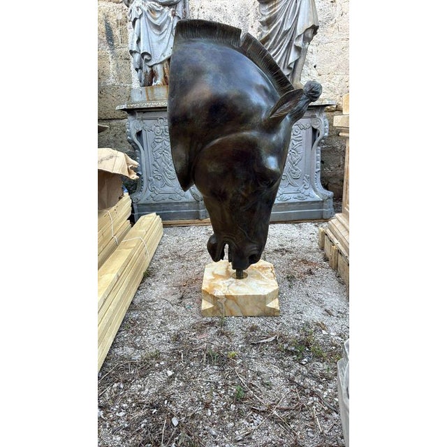 Impressive large-scale bronze sculpture representing the head of a Greek horse, inspired by the powerful and timeless...