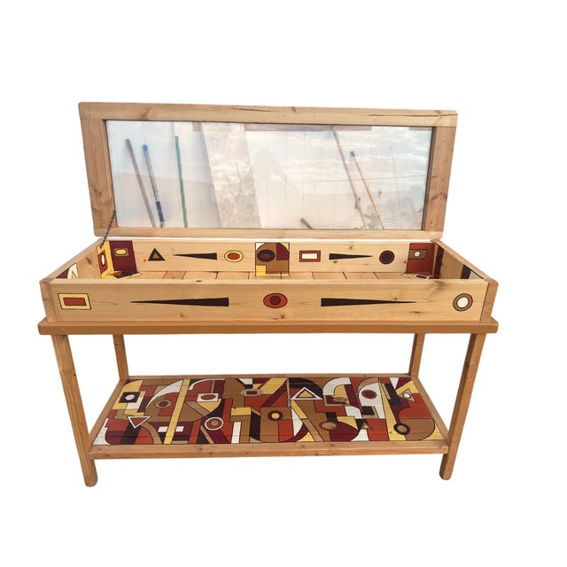 Striking vintage wood and glass display case featuring hand-painted geometric artwork in warm shades of rust, burgundy,...