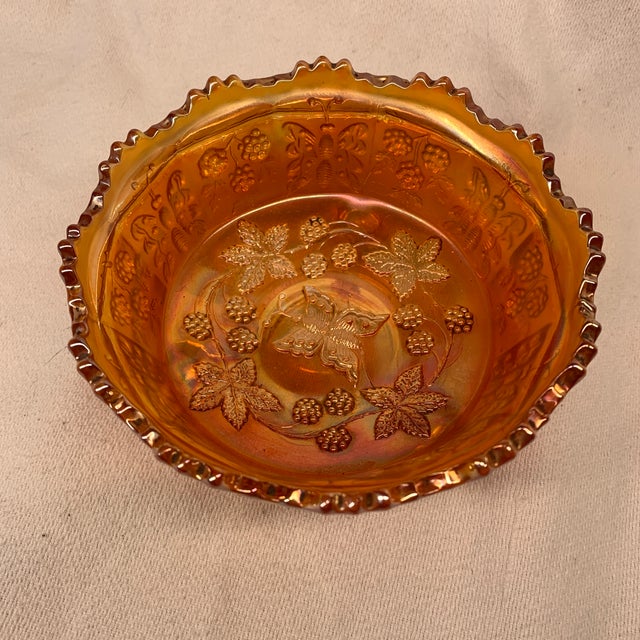 The item shown is a vintage Fenton Art Glass marigold carnival glass footed bowl featuring the iconic Butterfly and Berry...