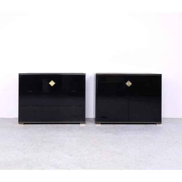 Vintage set of two cabinets designed by pierre vandel, paris. The cabinets are made of black lacquered wood and covered...
