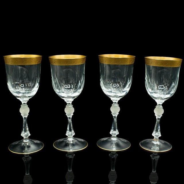 This is a set of four antique wine glasses. A French, gilt decorated stem glass, dating to the Art Deco period, circa...