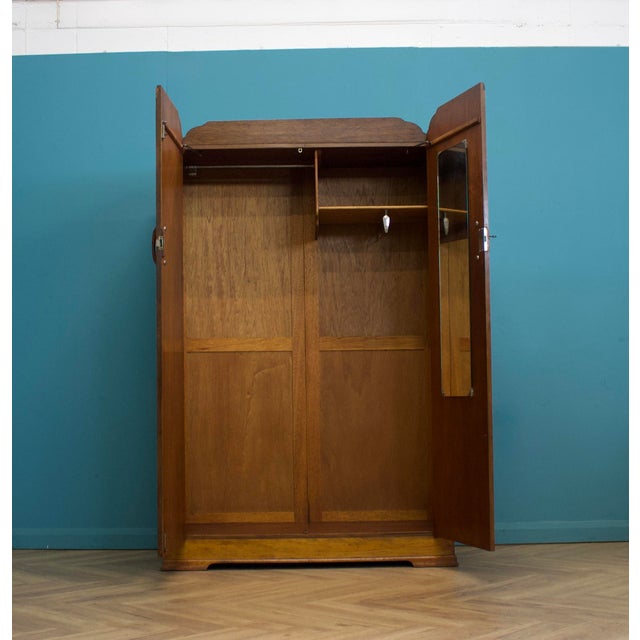 Beautiful Art Deco wardrobe with stunning figured walnut veneers and striking book-matched grain. Features original...