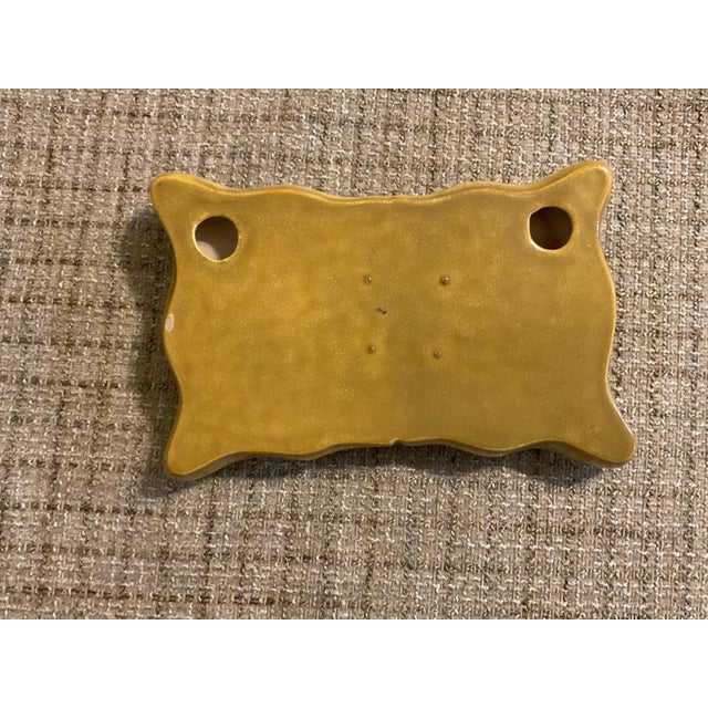 This ceramic wall plaque is in good condition . One tiny bottom left . A western seen of a cowboy who just got bucked off...