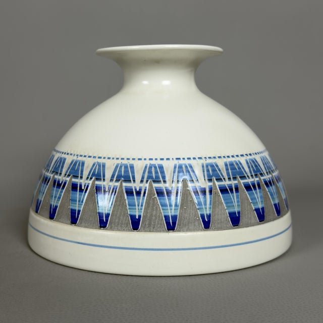 An interesting piece of Italian artistic ceramics, featuring a modern and graphic design. This vase features a flattened...