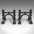 This is a pair of antique tool rests. An English, ebonised cast iron fireside poker stand in Aesthetic Movement taste,...