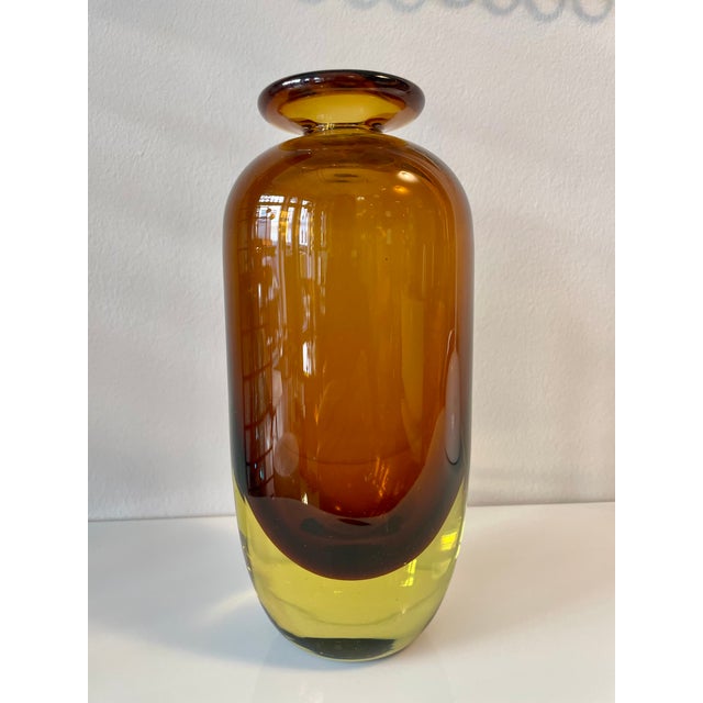 A particularly beautiful two-tone, mouth-blown vase in yellow and amber colors. This piece has an attribution mark, I am...