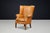 An exceptional and highly sculptural English barrel-back wing chair, dating to circa 1870, distinguished by its commanding...