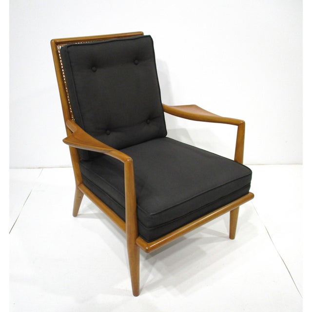 A very rare Wing lounge chair with button back cushion, sculptural mahogany wood frame and caned back. The piece has...