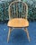 Nice set of solid oak Windsor chairs by Nichols and stone. Features iconic hoop-backed silhouette, spindles that provide a...