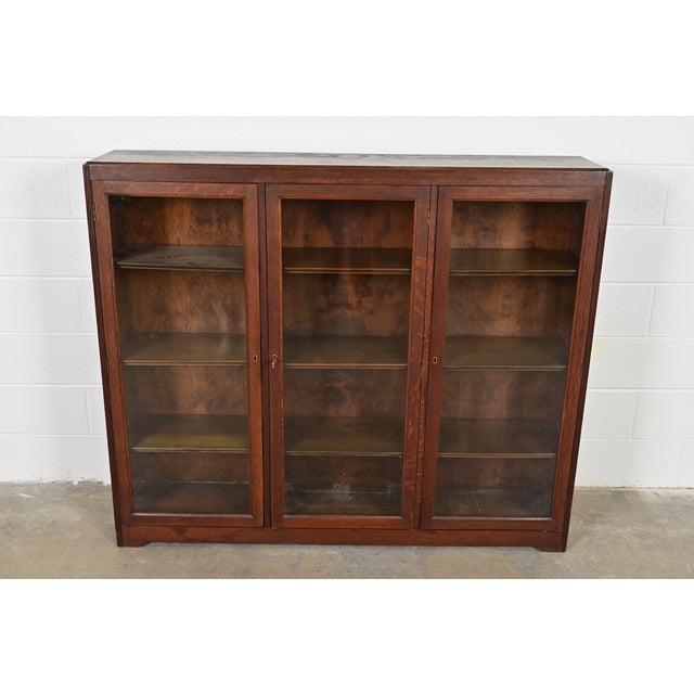 A beautiful antique Mission or Arts & Crafts period triple bookcase cabinet In the manner of Charles P. Limbert Co. USA,...