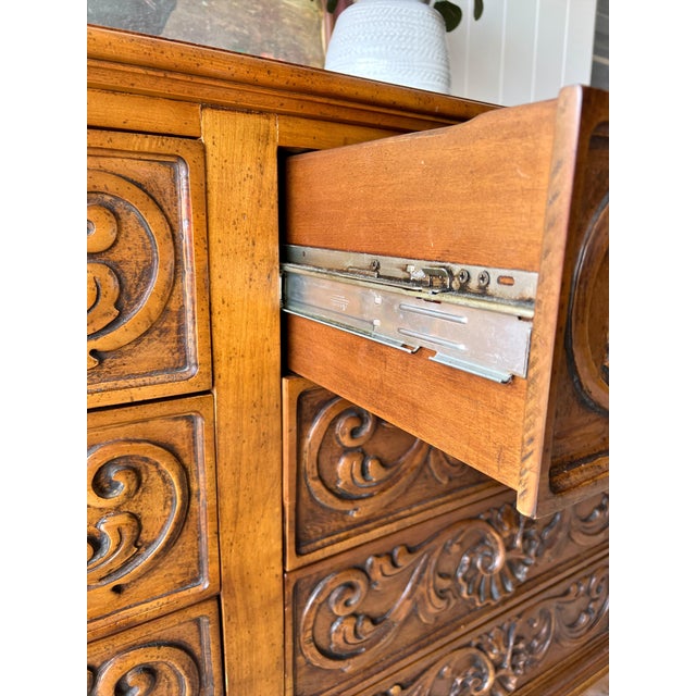 Beautiful vintage dresser featuring richly carved drawer fronts and a warm honey-toned wood finish. This statement piece...