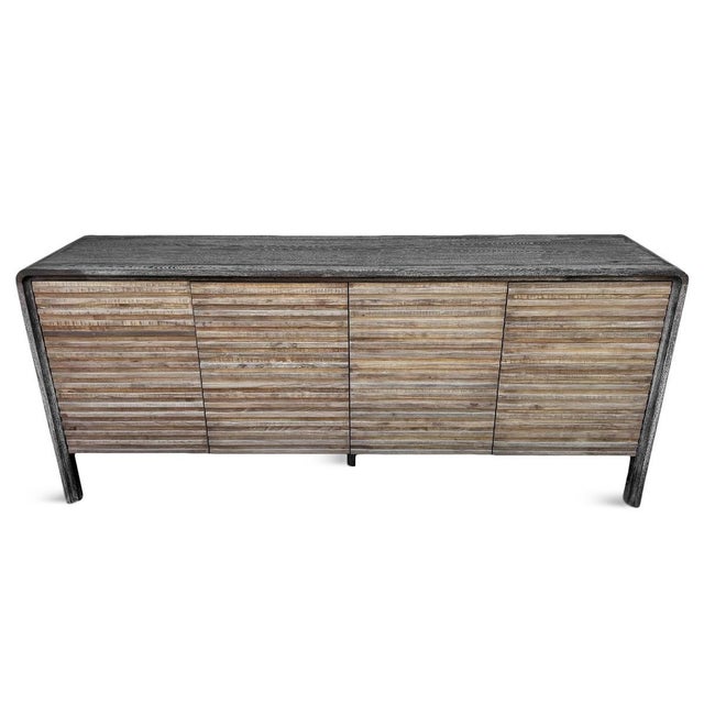 Crafted from elm wood, this modern sideboard features warm tan-brown carved doors contrasted by a black finish across the...