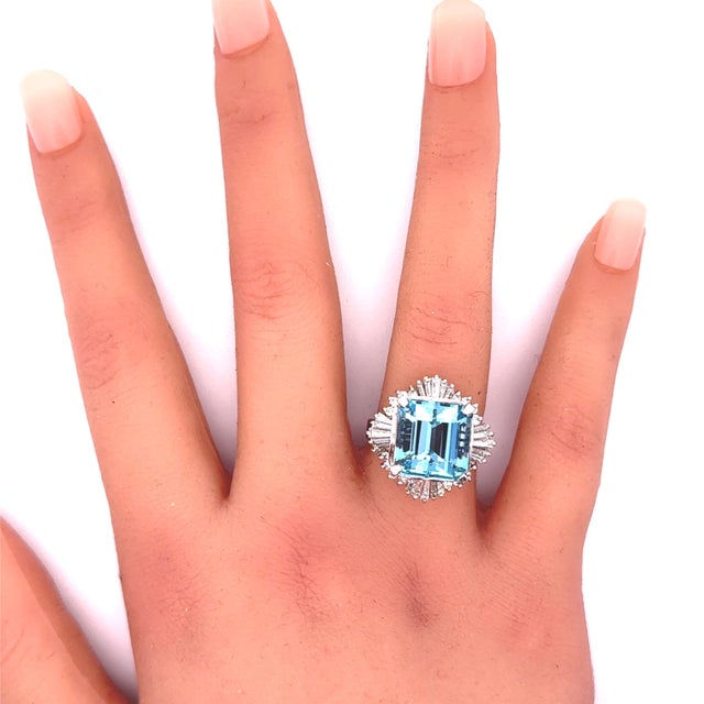 A striking aquamarine, weighing 9.68 carats, is the focal point of this contemporary ring. The aquamarine, cut in a...