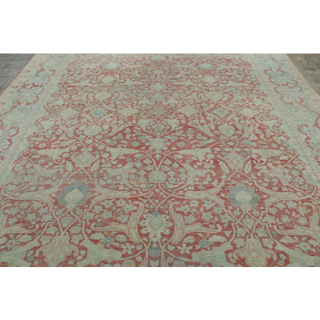Hand-knotted in wool, this 10x13 antique Tabriz rug is a refined example of one of the most celebrated weaving traditions...