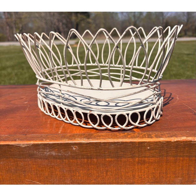 Beautiful and elegant French Country white wire basket featuring a scalloped rim and a delicate but substantial wirework...