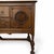 An imposing antique sideboard in the Jacobean Revival tradition, combining richly figured wood surfaces with strong...
