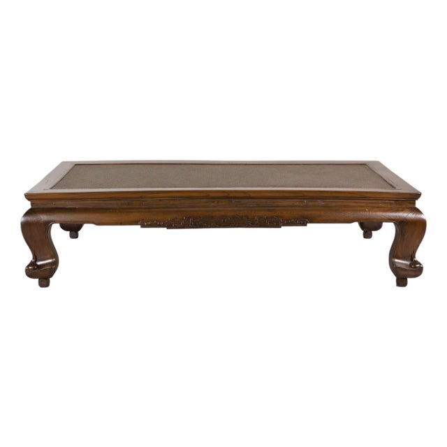 Antique Chinese Elm Opium Bed Coffee Table with Woven Rattan Top and Scroll Legs For Sale