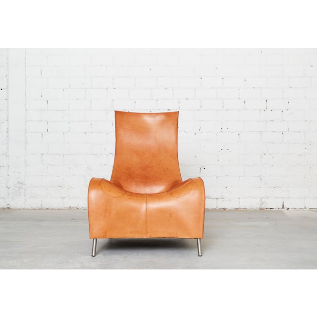 Sculptural design by German product and furniture designer Matthias Hoffmann. The armchair is fully upholstered in cognac-...