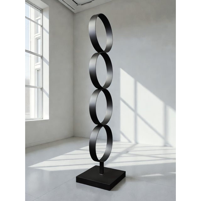 Circa is a contemporary steel sculpture by artist Nicholas Turner, defined by a vertical sequence of four circular forms....