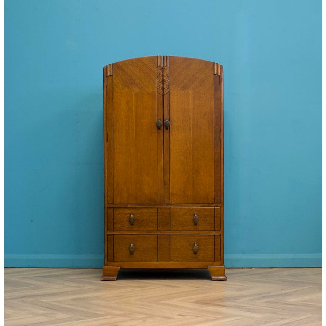 An impressive quality Art Deco oak tallboy or housekeeper’s cupboard, circa 1930s Made by Harris Lebus for Utility...