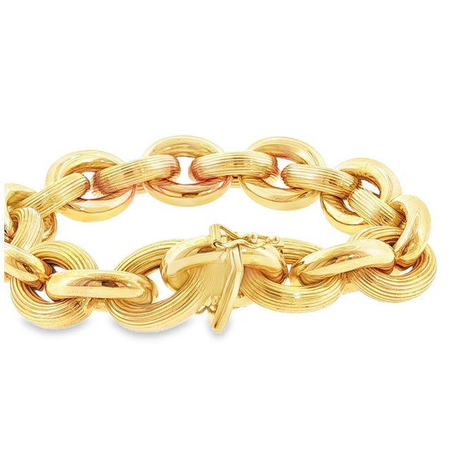 A Vintage 14k yellow chunky gold link bracelet. The links are a combination of textured and polished. The clasp is secure...