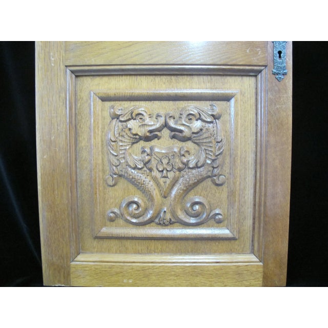 Stunning antique carved wood architectural door panel. Features two carved panels, each depicting a pair of stylized...