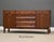 A mid century modern walnut sideboard credenza with two doors and six drawers designed by Edward Wormley for Dunbar....