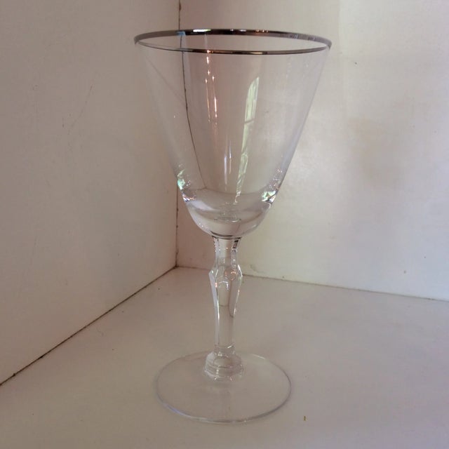 This is a vintage set of 6 crystal platinum rim etched Fostoria on the bottom wine glasses.