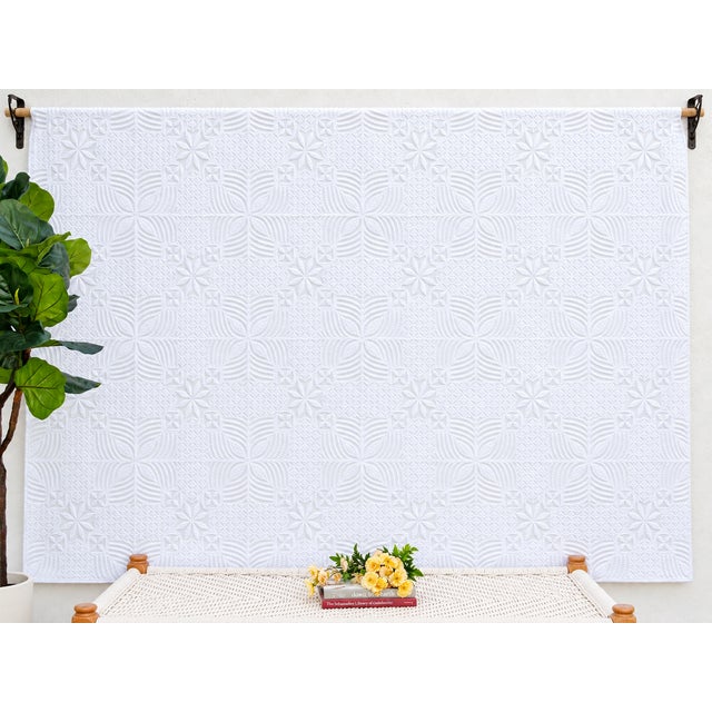 A lightweight cotton coverlet from Western India, beautifully adorned with intricate handcrafted appliqué cutwork. The...