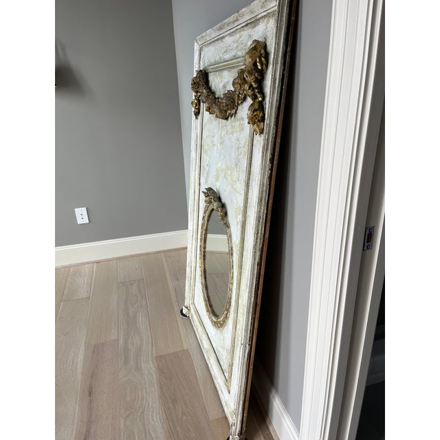 Painted wooden mirror with Light green and neutral paint and distressing. Gold accents on the carving. Purchased from...