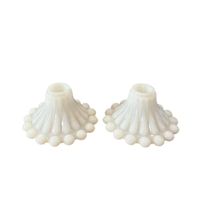 A charming g pair of vintage milk glass Berwick Boopie candle holders. Each features a beaded milk glass rim to the foot...