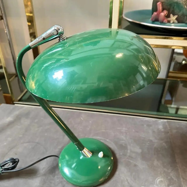 A desk lamp designed and manufactured in Italy in the Sixties in the manner of Stilnovo. Lamp is in good condition overall...