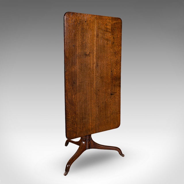 This is an antique parlour drinking table. A Scottish, oak tilt-top country house occasional table, dating to the late...