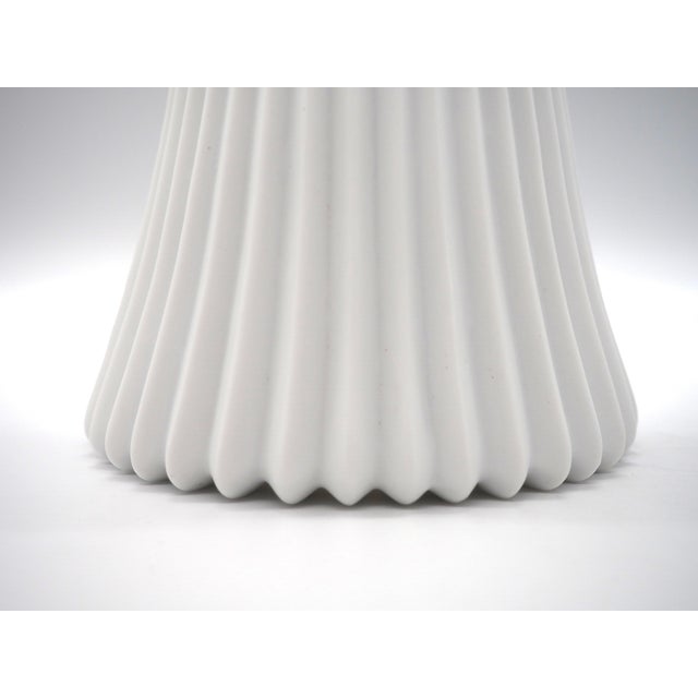 These window lamps combine discreet elegance with practical function. The white, fluted, conical lampshades diffuse a...