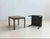 This compact side table from the 1970s is characterized by its minimalist, linear design and dark-stained wood surface....