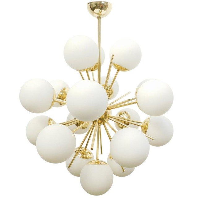 Italian sputnik chandelier with 18 matte white Murano glass globes mounted on brass frame in lacquered polished brass...