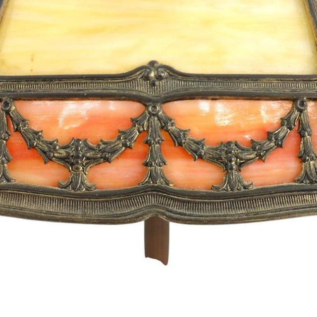 This Arts and Crafts table lamp features a distinctive 8-panel slag glass shade in the manner of Bradley & Hubbard, dating...