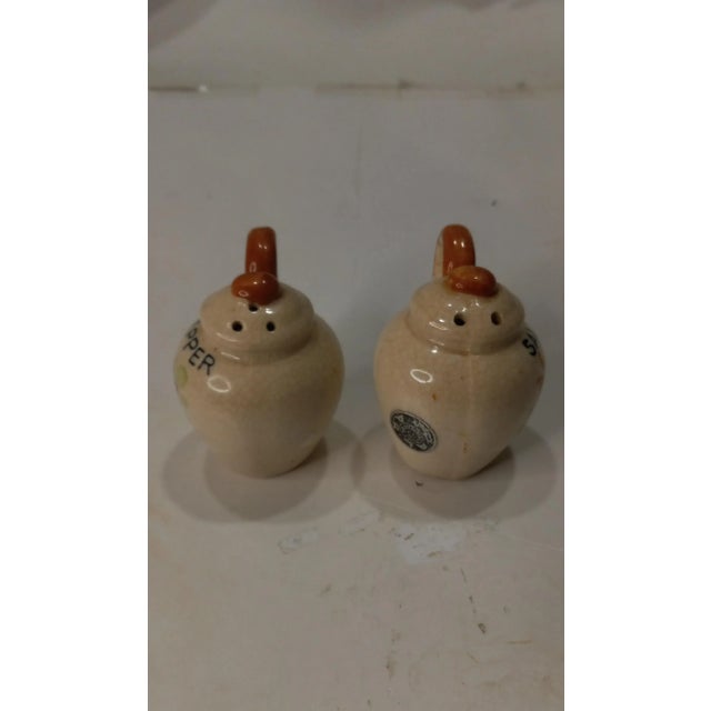 Pair of Vintage Jug Shaped Ceramic Salt and Pepper Shakers Made in Japan 1940s. The brand is Pal * Mar. The Pepper shaker...