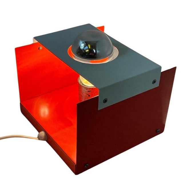 Vintage space age design wall mounted lamp. Made from metal that is colored orange and white. Gives and extra coolness by...