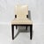 A pair of side dining chairs from sought-after designer Holly Hunt. Handmade with a solid walnut frame, a veneered back...