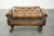 This unique and elegant English Chesterfield ottoman, made of cowhide leather, stands on casters and is finished with...