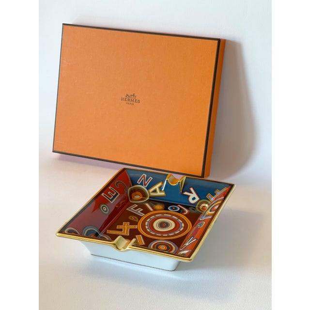 Limited Edition Hermes Tohu Bohu multi-color porcelain ashtray, with notches and rim gilded with gold and base covered...