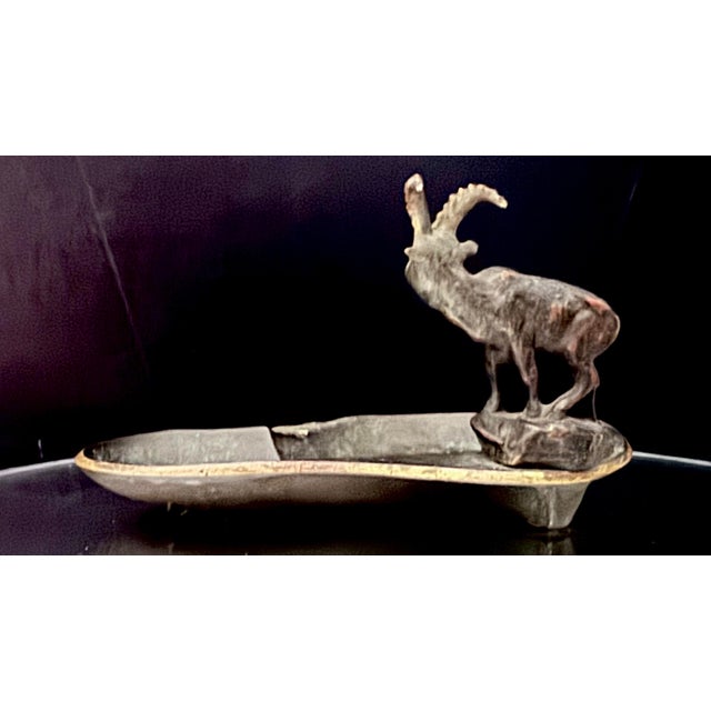 Striking early 20th-century French cast iron figural ashtray featuring a finely modeled Alpine ibex (chamois) atop an...